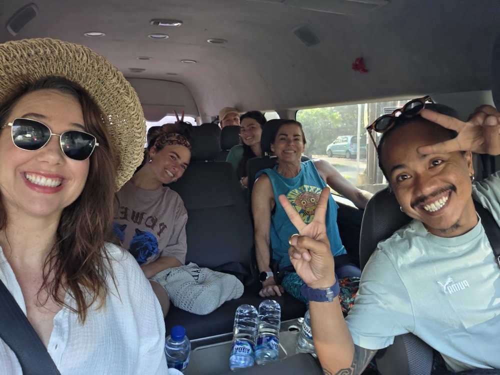 A group of happy travelers riding together in the tour van