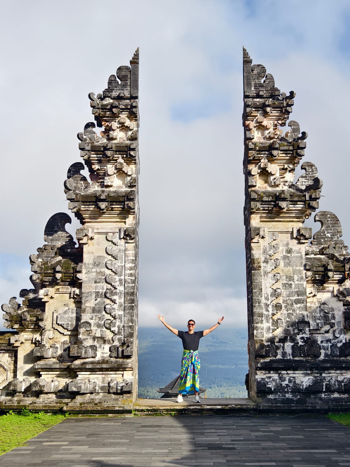 A joyful guest at a Balinese temple gate
