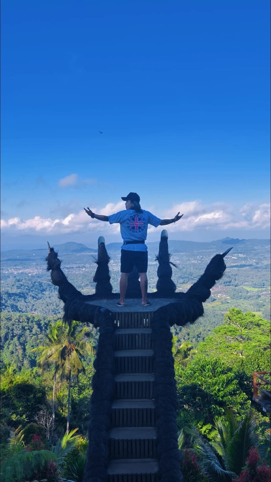 A traveler at a grand Balinese statue