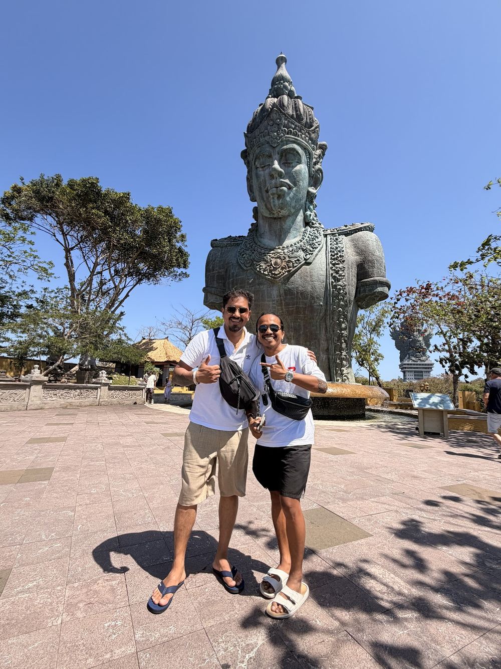 Guests posing in front of the Garuda Wisnu Kencana statue